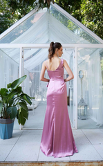 Asymmetric neckline with ruffled edges and side slits as well as a floor length evening dress