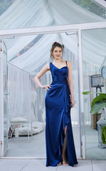 Asymmetric neckline with ruffled edges and side slits as well as a floor length evening dress