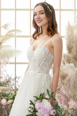 Ivory thin shoulder strap sheer and floor length wedding dress